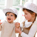 Girls wearing matching pink flamingo snapback hats. Cubs & Co. Australia.