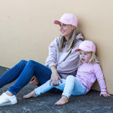 Matching mum and daughter wearing pink baseball caps. Cubs & Co. Australia