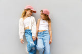 matching oink good vibes caps for sisters