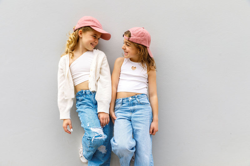matching oink good vibes caps for sisters